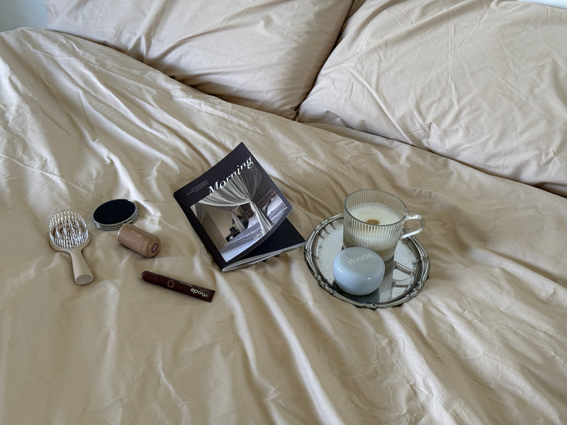 An open journal and pen beside a morning cup of coffee in soft natural light.
