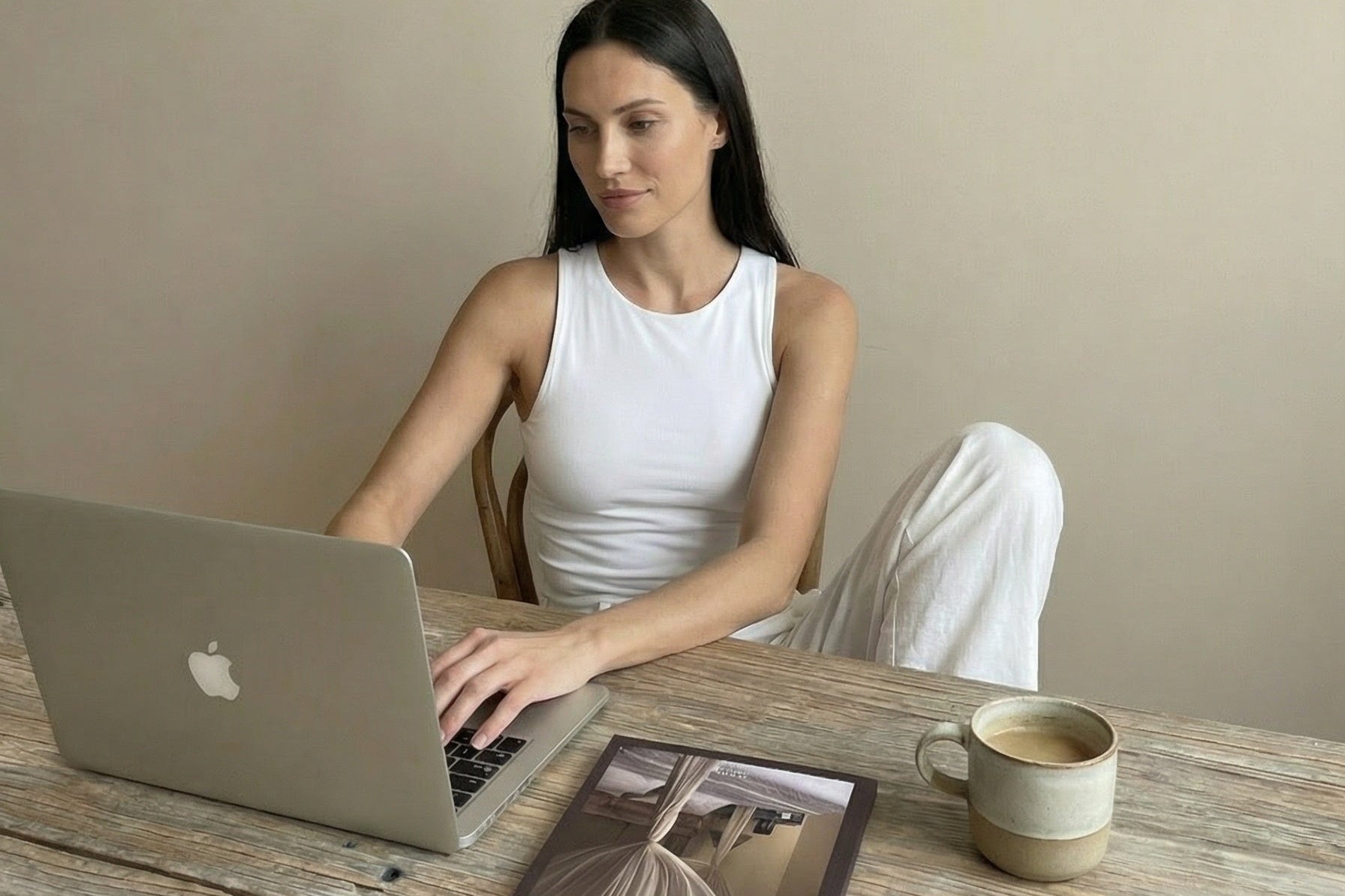 Woman working with the ORA guided journal and educational journaling resources for self-reflection and mindful living.